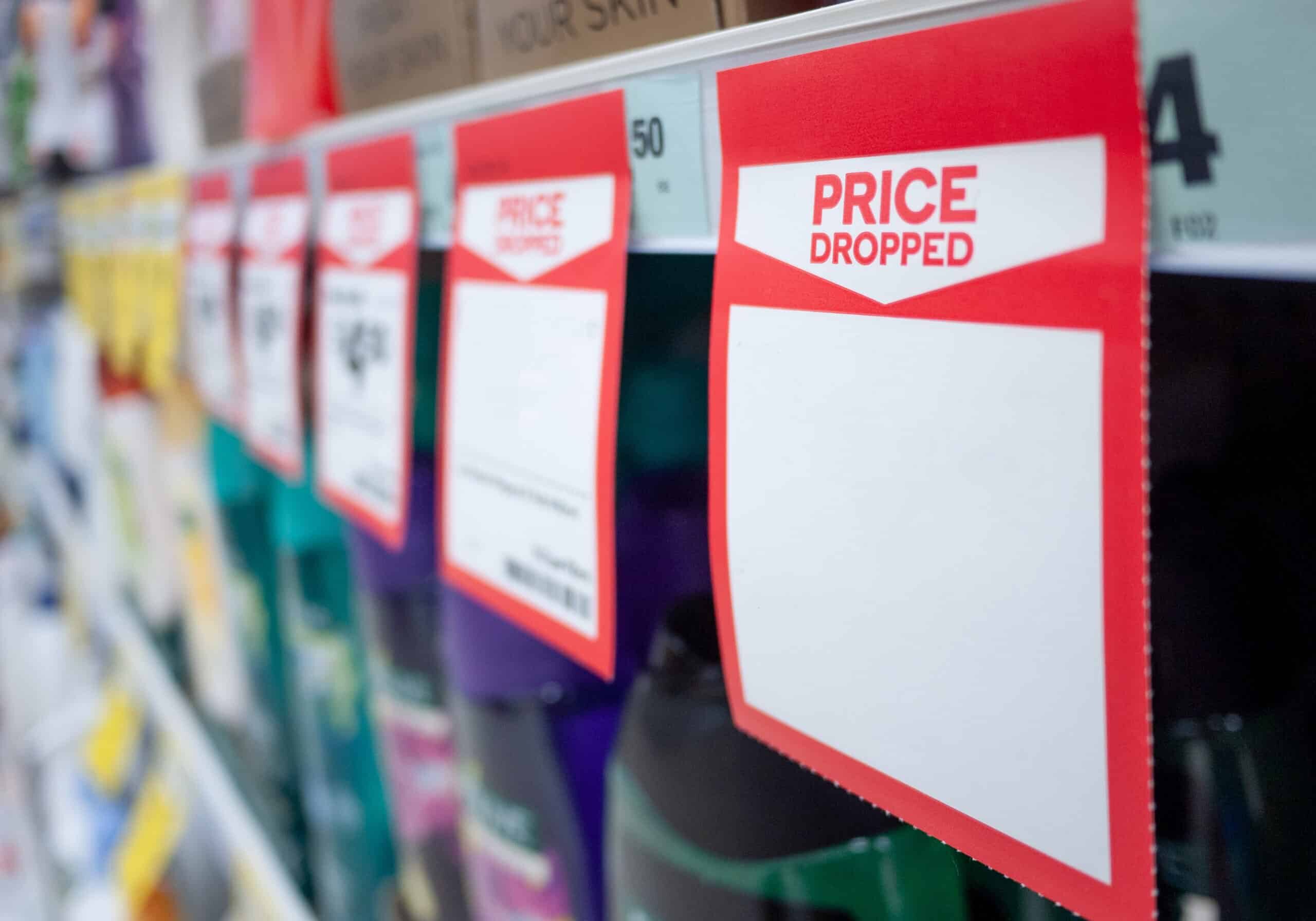 Mock up template of paper tag shows price dropped with blank space for text on supermarket shelf.